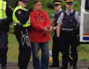 Ron Tremblay, holding sacred pipe, is arrested. Photo courtesy of @1tnb