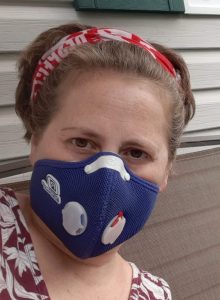 A woman wearing a blue face mask or ventilator. 