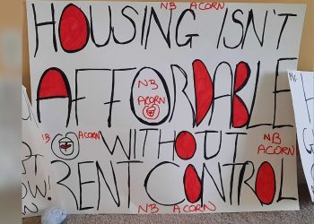 A protest sign that reads, "Housing isn't affordable without rent control."
