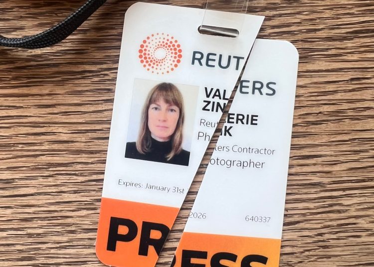 Valerie Zink's torn up Reuters press pass.