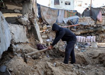 Photos: Palestinian man searches for remains of wife, children in rubble of Gaza Strip