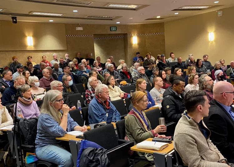 A large crowd of approximately 170 residents sitting in an auditorium at Mount Allison University for a public meeting on the proposed Tantramar gas plant.