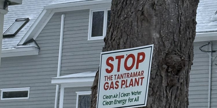 Sign on a tree in Tantramar reads: "Stop the Tantramar Gas Plant. Clean air, clean water, clean energy for all."