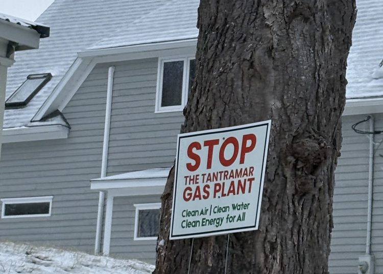 Sign on a tree in Tantramar reads: "Stop the Tantramar Gas Plant. Clean air, clean water, clean energy for all."